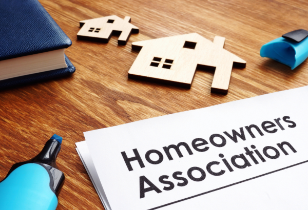 a desk with papers that read, "homeowner's association"